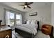 Serene bedroom with a ceiling fan, large windows, and comfortable seating at 767 Farmstead Rd, Suwanee, GA 30024