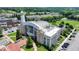 Exterior view of City Hall building with modern design, manicured landscaping, and ample parking at 767 Farmstead Rd, Suwanee, GA 30024