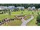 Expansive community green space with a rock bed stream, manicured lawns, and surrounding residential homes at 767 Farmstead Rd, Suwanee, GA 30024