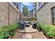 Private courtyard featuring elegant brick walls, a paved patio, and outdoor seating for relaxation and entertaining at 767 Farmstead Rd, Suwanee, GA 30024