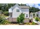 Charming two-story home featuring white siding, a brick foundation, and a cozy front porch at 767 Farmstead Rd, Suwanee, GA 30024