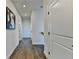 Hallway featuring hardwood floors, neutral paint, and modern lighting fixtures at 767 Farmstead Rd, Suwanee, GA 30024