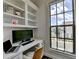Bright home office featuring custom built-ins and a large window overlooking the neighborhood at 767 Farmstead Rd, Suwanee, GA 30024