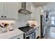 Bright kitchen boasts a stainless steel range hood and appliances, along with white subway tile backsplash at 767 Farmstead Rd, Suwanee, GA 30024