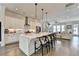 Modern kitchen with white cabinets, large island, and pendant lighting at 767 Farmstead Rd, Suwanee, GA 30024
