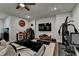 The modern living room offers a home gym, a bar, a large television, and an aquarium at 767 Farmstead Rd, Suwanee, GA 30024