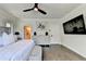 Stylish main bedroom shows hardwood floors, ceiling fan, ensuite bathroom, and decor at 767 Farmstead Rd, Suwanee, GA 30024