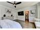 Hardwood floors and a ceiling fan are visible in this stylish and decorated main bedroom at 767 Farmstead Rd, Suwanee, GA 30024