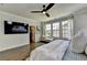 Bright, spacious main bedroom features hardwood floors, ceiling fan, windows, and walk-in closet at 767 Farmstead Rd, Suwanee, GA 30024