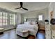 Spacious main bedroom with a ceiling fan, hardwood floors, and plenty of natural light at 767 Farmstead Rd, Suwanee, GA 30024