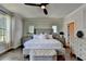 Main bedroom features a bed, hardwood floors, windows, and decorative furnishings at 767 Farmstead Rd, Suwanee, GA 30024