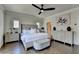 Bright main bedroom with hardwood floors features a ceiling fan, and decorative furniture at 767 Farmstead Rd, Suwanee, GA 30024
