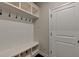 Convenient mudroom features a bench with storage cubbies and coat hooks near an exterior door at 767 Farmstead Rd, Suwanee, GA 30024