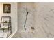 Modern walk-in shower with marble tiling, shower bench, and sleek fixtures at 767 Farmstead Rd, Suwanee, GA 30024