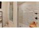 Luxurious walk-in shower featuring marble tiling, glass enclosure, and modern fixtures at 767 Farmstead Rd, Suwanee, GA 30024