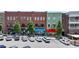 Street view showcasing storefronts with parking and manicured trees in a vibrant mixed-use development at 767 Farmstead Rd, Suwanee, GA 30024