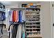 Walk-in closet boasts custom shoe racks, custom shelving and ample hanging space at 767 Farmstead Rd, Suwanee, GA 30024