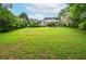 Expansive backyard featuring lawn, mature trees, and a deck, blending indoor/outdoor living at 830 Montego Sw Way, Lilburn, GA 30047
