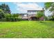 Expansive backyard featuring lawn, mature trees, and a deck, blending indoor/outdoor living at 830 Montego Sw Way, Lilburn, GA 30047