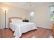 Comfortable bedroom features hardwood floors, a full bed, and lots of natural light at 830 Montego Sw Way, Lilburn, GA 30047