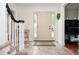 Inviting foyer with tile floor and staircase creates a welcoming entry to the home at 830 Montego Sw Way, Lilburn, GA 30047