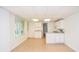 A kitchenette features white cabinets and countertops with neutral tile flooring at 830 Montego Sw Way, Lilburn, GA 30047
