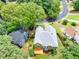 Aerial view of a gray roof home featuring a wooden deck and fenced backyard surrounded by lush greenery at 1876 Hamby Place Nw Dr, Acworth, GA 30102