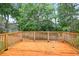 Wooden back deck with railing surrounded by lush greenery and mature trees at 1876 Hamby Place Nw Dr, Acworth, GA 30102
