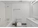 Bright white bathroom featuring a tub/shower combo, toilet, and vanity with a large mirror at 1876 Hamby Place Nw Dr, Acworth, GA 30102