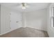 Bedroom featuring neutral carpeting, a double door closet and a ceiling fan at 1876 Hamby Place Nw Dr, Acworth, GA 30102