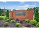 Welcome to Hamby Place, featuring a wooden sign with brick columns, and lush landscaping at 1876 Hamby Place Nw Dr, Acworth, GA 30102