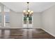 Elegant dining room with wood floors, stylish chandelier, and a view of the backyard at 1876 Hamby Place Nw Dr, Acworth, GA 30102