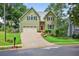 Two-story home with green siding, black shutters, an attached garage, and a well-maintained front lawn at 1876 Hamby Place Nw Dr, Acworth, GA 30102
