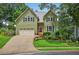 Charming two-story home with green siding, black shutters, manicured landscaping, and an attached garage at 1876 Hamby Place Nw Dr, Acworth, GA 30102