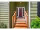 Charming front entrance with wooden steps and a red front door, inviting curb appeal at 1876 Hamby Place Nw Dr, Acworth, GA 30102