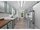 Galley kitchen with light wood floors, stainless steel appliances and ample countertop space at 1876 Hamby Place Nw Dr, Acworth, GA 30102