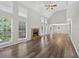 Bright living room with hardwood floors, fireplace, vaulted ceiling, and large windows showcasing natural light at 1876 Hamby Place Nw Dr, Acworth, GA 30102