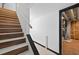 A modern staircase with wood and white risers leads to a finished area, and has access to utilities at 1876 Hamby Place Nw Dr, Acworth, GA 30102