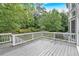 Back deck with gray floor and a view of the wooded yard at 212 Thorncliff Way Way, Acworth, GA 30101