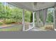 Charming back porch with white railings and decorative curtains overlooking the yard at 212 Thorncliff Way Way, Acworth, GA 30101