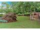 Tranquil backyard retreat with well-manicured lawn, mature trees, and lush landscaping offers a serene outdoor space at 212 Thorncliff Way Way, Acworth, GA 30101