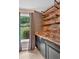 Charming bar area with wood paneling, floating shelves, and a view of the lush backyard at 212 Thorncliff Way Way, Acworth, GA 30101
