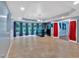 Spacious basement area with a bar, tile flooring, and ample natural light from large windows at 212 Thorncliff Way Way, Acworth, GA 30101