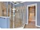 Luxurious bathroom featuring a glass shower with a tile surround and a walk-in closet at 212 Thorncliff Way Way, Acworth, GA 30101