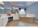 Bathroom featuring dual vanities, a soaking tub, and tile floors at 212 Thorncliff Way Way, Acworth, GA 30101