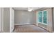 Bedroom featuring neutral carpet, a ceiling fan, a window, and neutral colored walls at 212 Thorncliff Way Way, Acworth, GA 30101