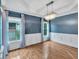 Traditional dining room featuring hardwood floors, wainscoting, and a decorative chandelier for an elegant aesthetic at 212 Thorncliff Way Way, Acworth, GA 30101