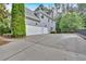 Long driveway leading to a three-car garage with clean, modern lines at 212 Thorncliff Way Way, Acworth, GA 30101