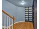 Hallway with wood floors, white and wood railing, and a built-in bookshelf in the corner at 212 Thorncliff Way Way, Acworth, GA 30101