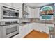 Gourmet kitchen with stainless appliances, gas range, custom cabinetry, and hardwood flooring, blending style with function at 212 Thorncliff Way Way, Acworth, GA 30101
